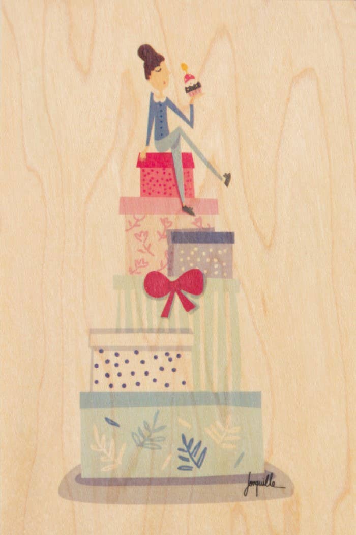 Carte postale NewUsed Collection en bois flexible illustrée d'une femme assise sur une pile de cadeaux d'anniversaire